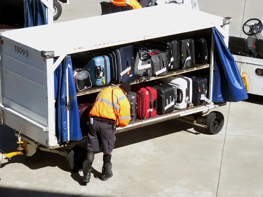 Smart luggage and normal bags being loaded on a plane