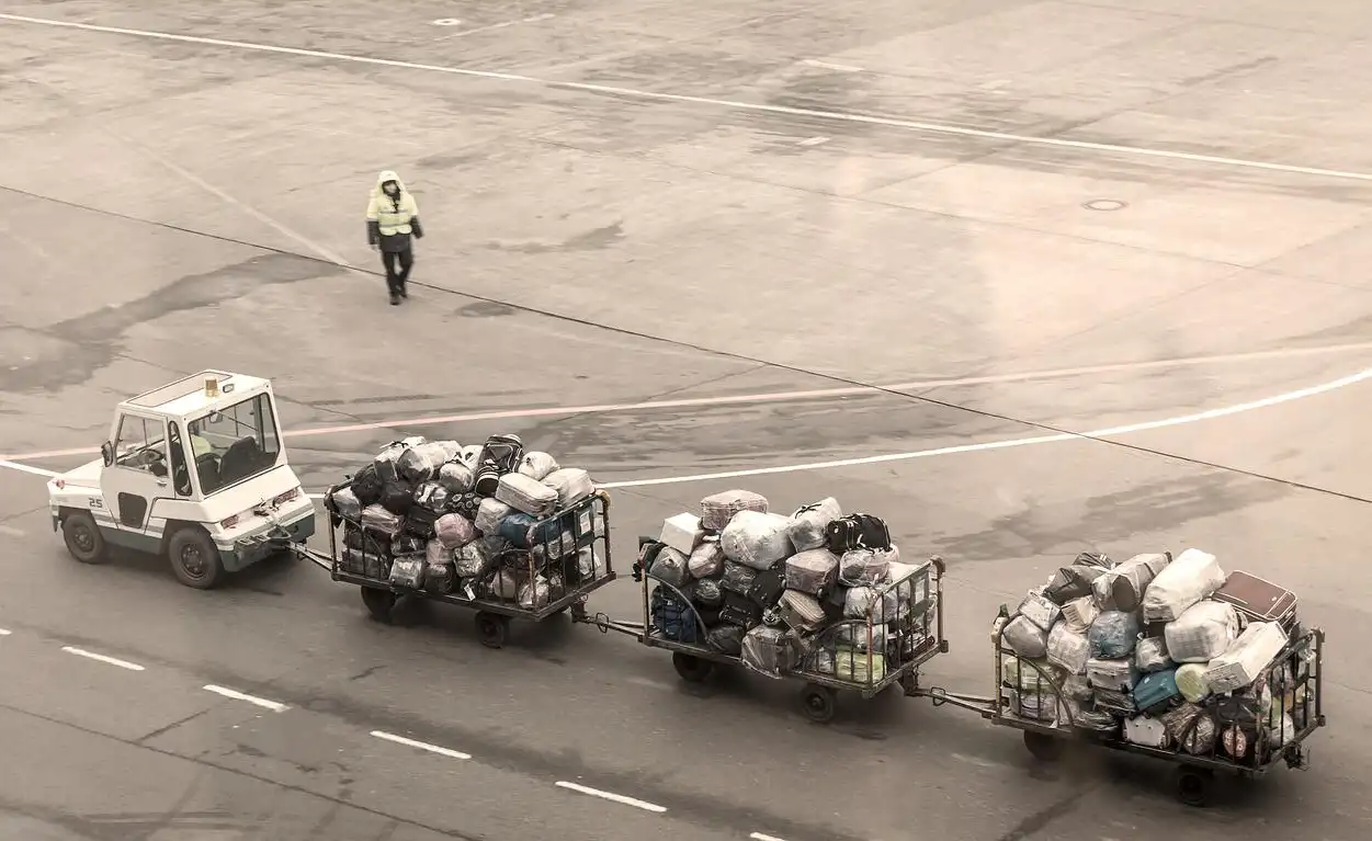 Bags wrapped in plastic film being loaded onto a plane
